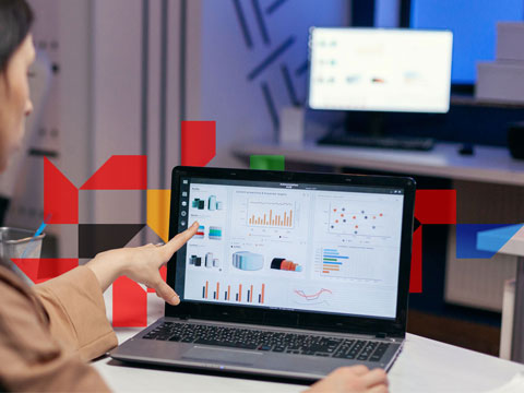 a woman pointing at a screen