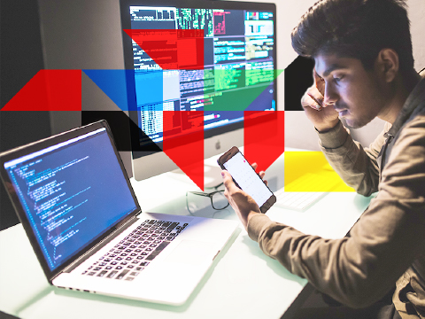 a man working on a computer and a monitor